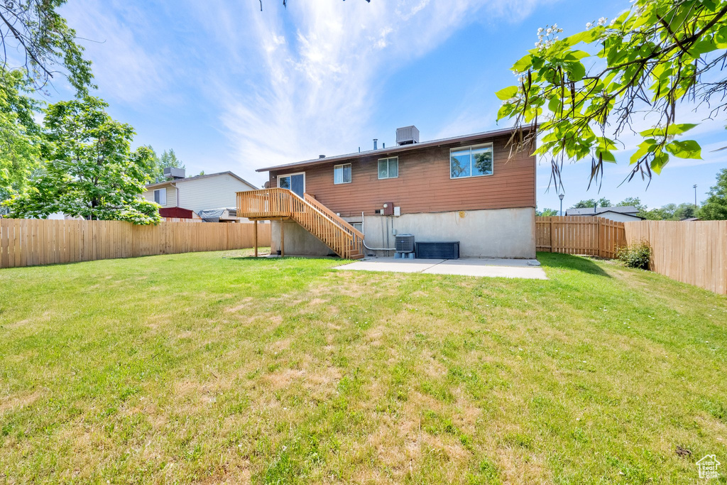 Rear view of house featuring a patio area and stairway