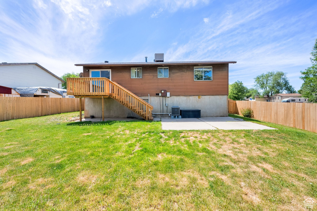 Rear view of house with a patio area, stairway, and a deck
