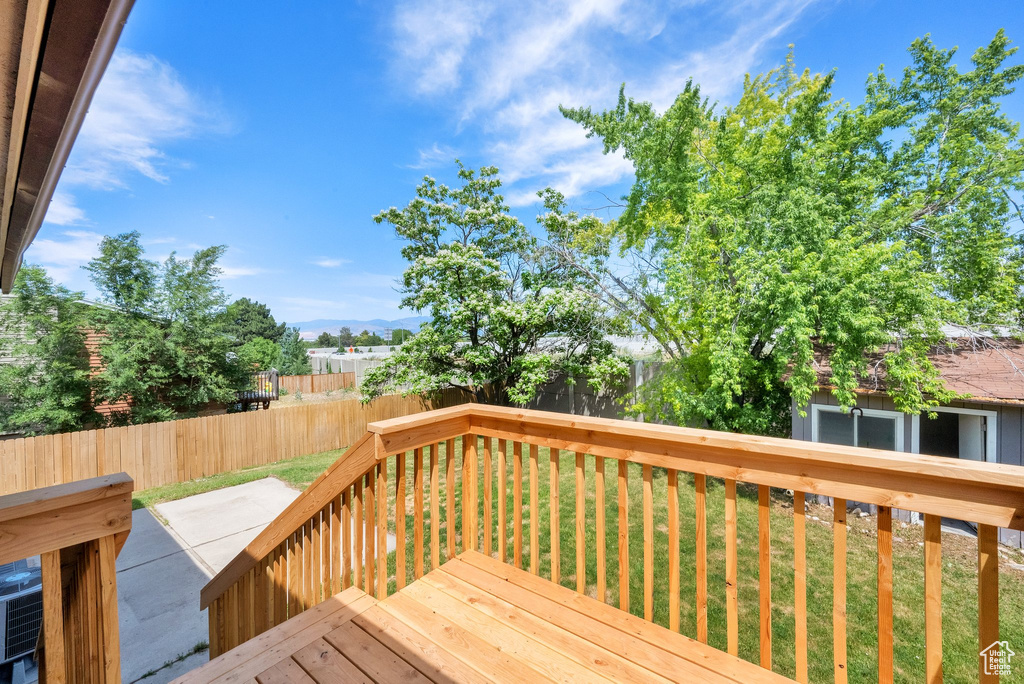 Deck with a mountain view and a patio