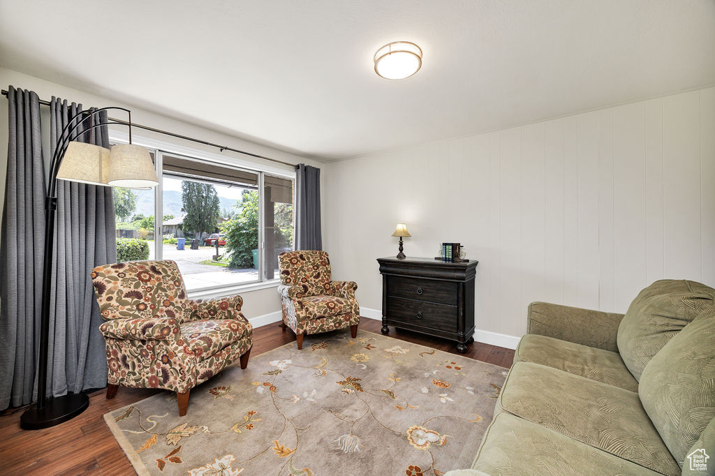 Sitting room with wood finished floors and baseboards