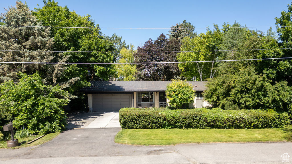 View of front facade featuring an attached garage and driveway