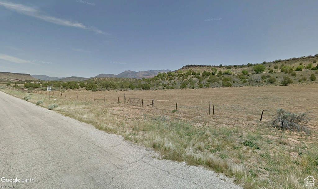 View of mountain backdrop featuring rural landscape