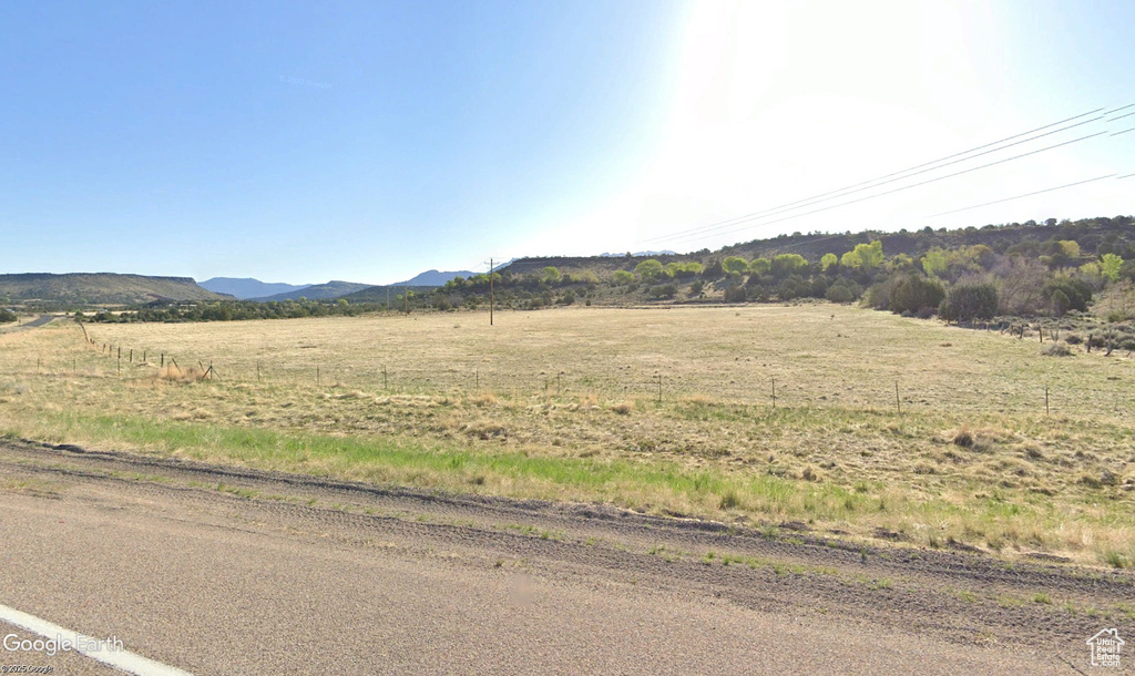 View of mountain backdrop with rural landscape