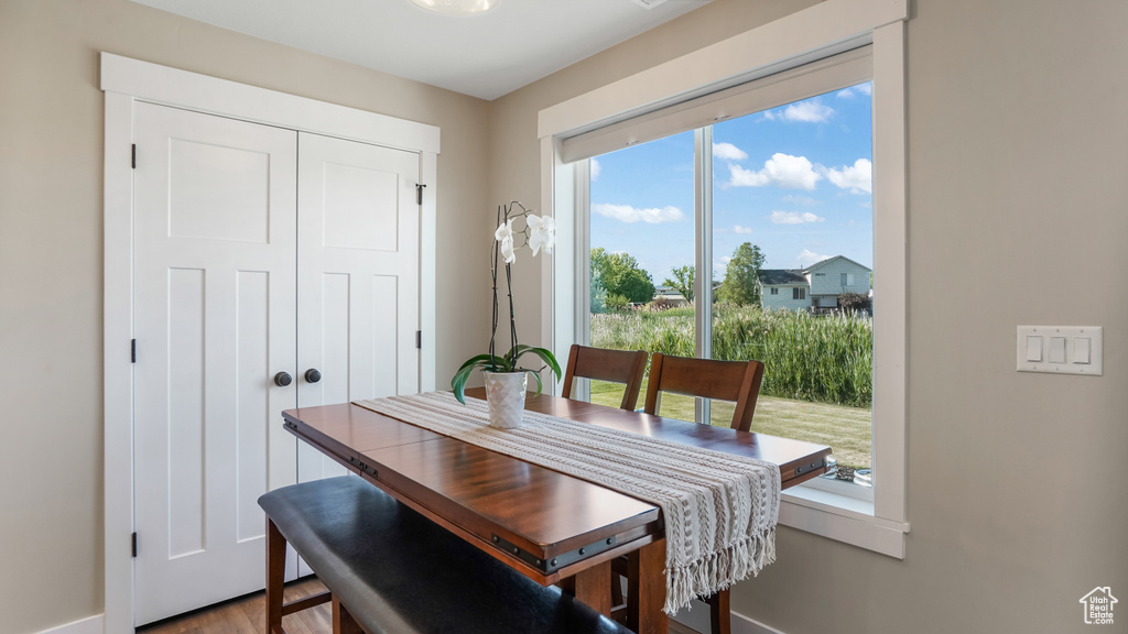 Dining area with healthy amount of natural light, baseboards, and wood finished floors