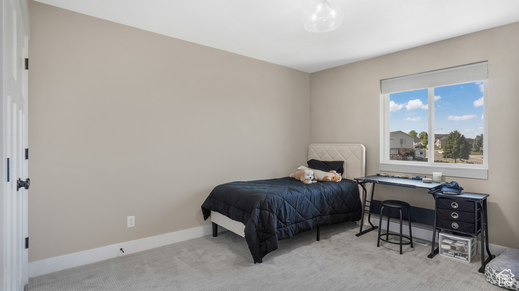 Bedroom featuring carpet floors and baseboards