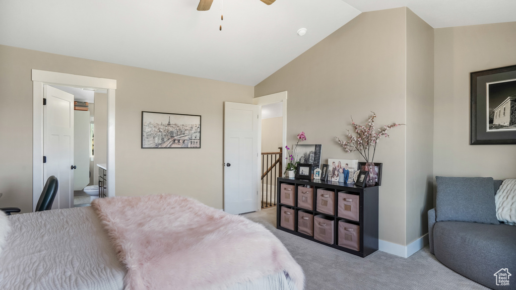 Bedroom featuring light colored carpet, lofted ceiling, ensuite bathroom, ceiling fan, and baseboards