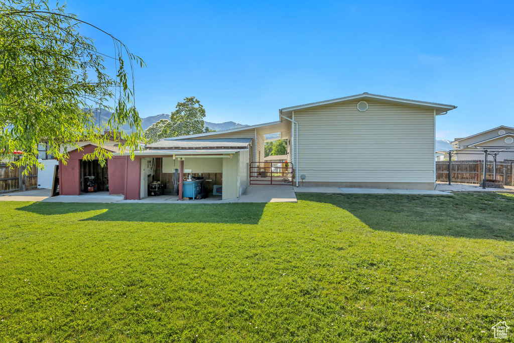 Back of property featuring a patio area and a mountain view