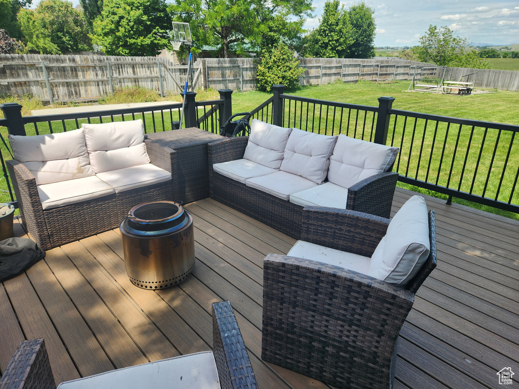 Wooden deck with an outdoor living space with a fire pit