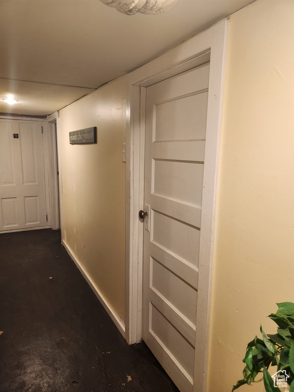 Hall with concrete floors and baseboards