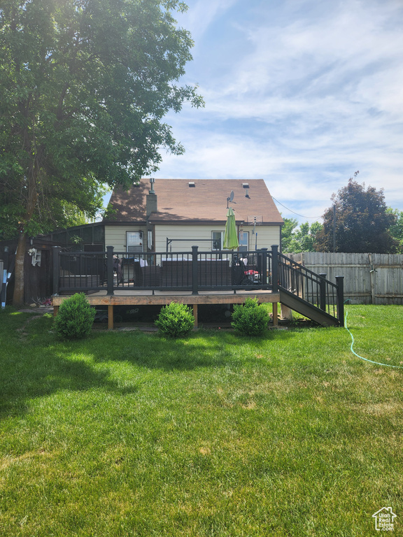 Back of house featuring a wooden deck