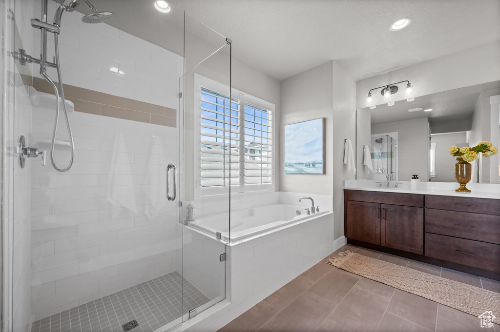 Bathroom with vanity, a garden tub, a stall shower, and recessed lighting