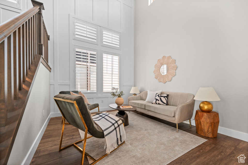 Living area featuring dark wood-style floors and baseboards
