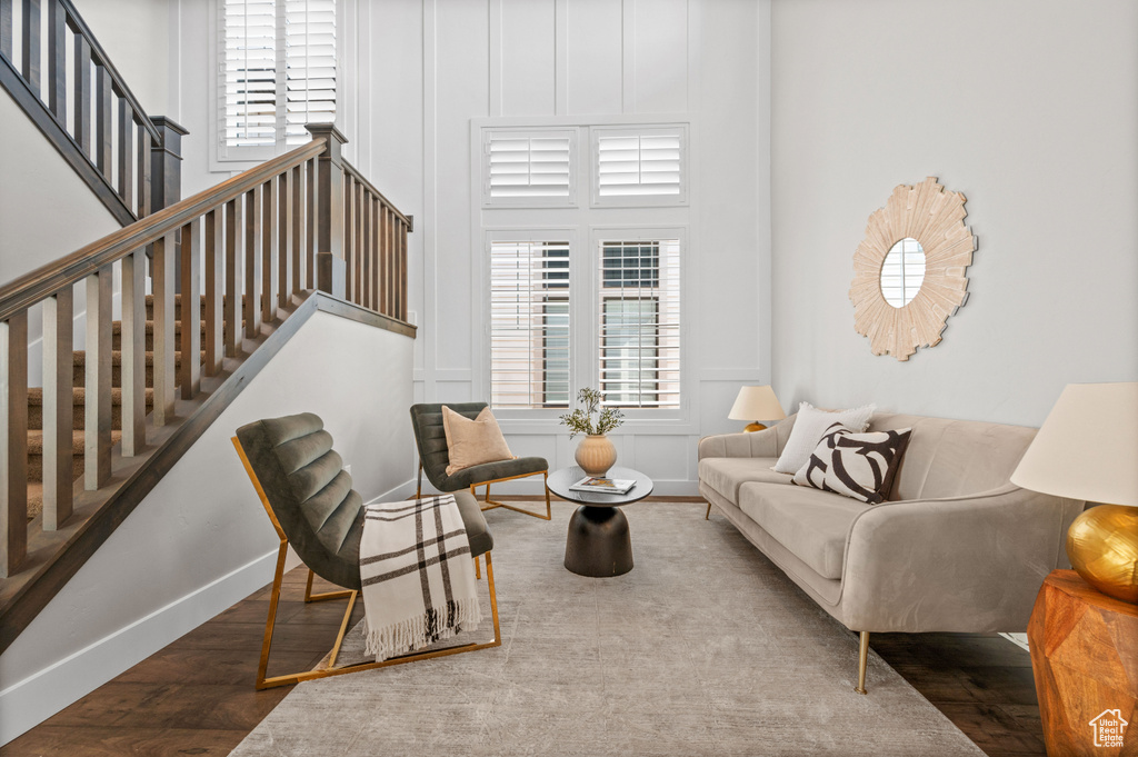 Living room featuring wood finished floors, stairway, and baseboards