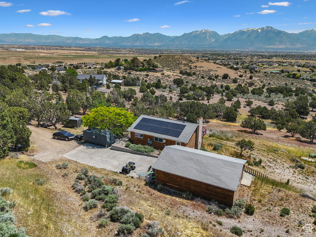 Aerial view of property and surrounding area with a mountain backdrop
