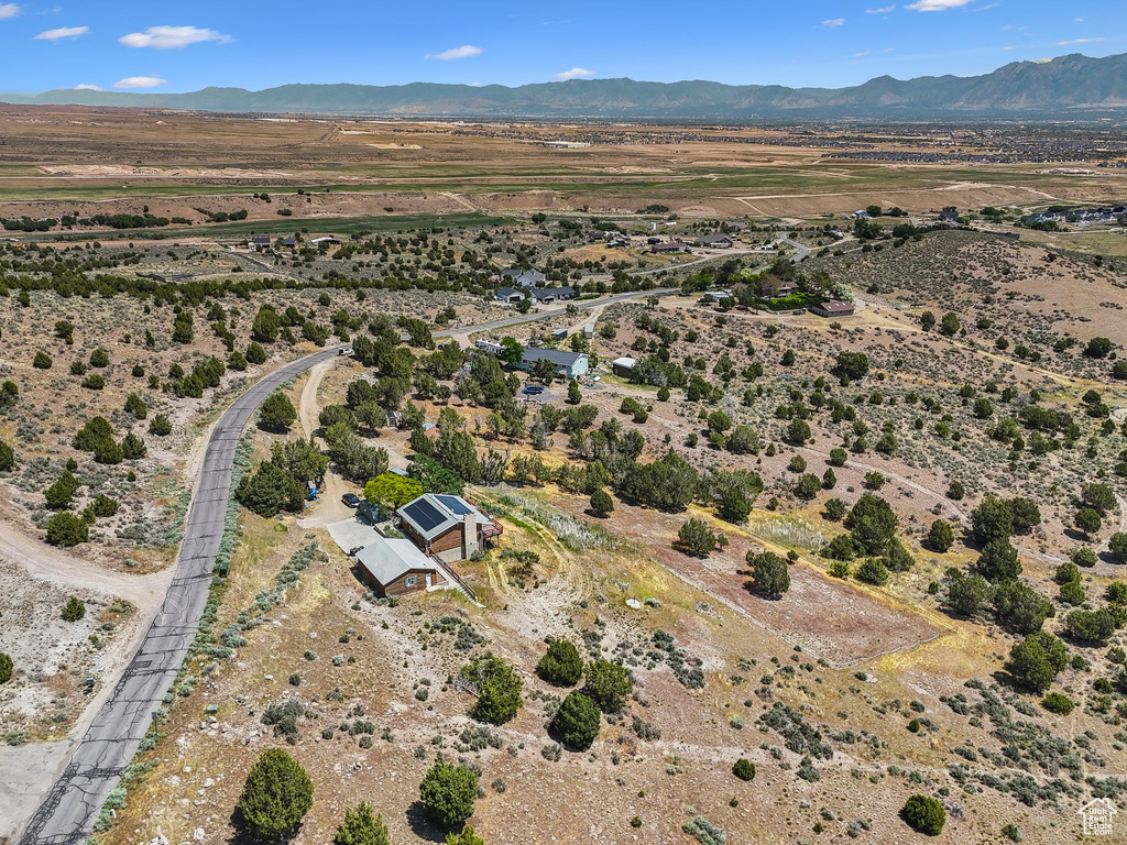 Aerial view of property and surrounding area with rural landscape, mountains, and a desert landscape