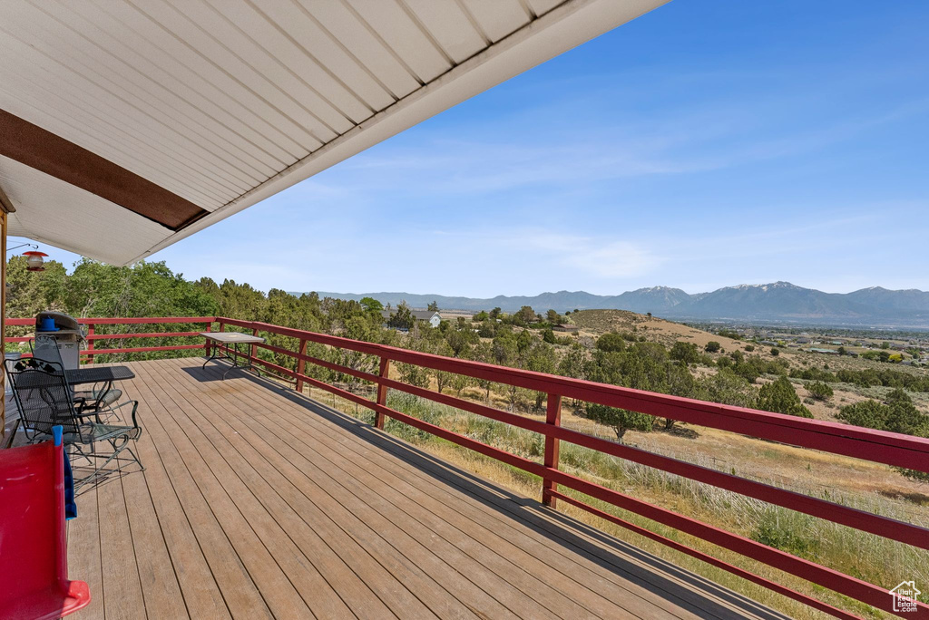 Wooden terrace featuring a mountain view