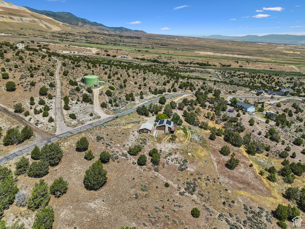Aerial view of property's location featuring rural landscape and a mountainous background
