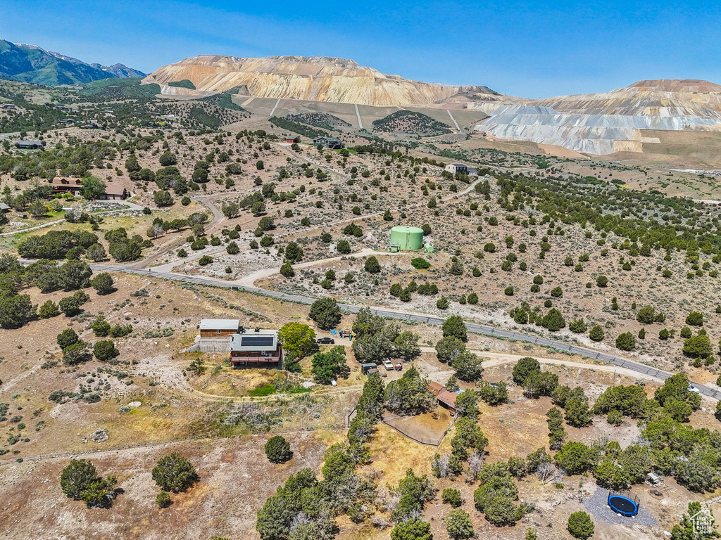 Aerial view of sparsely populated area with a mountain backdrop and a desert landscape