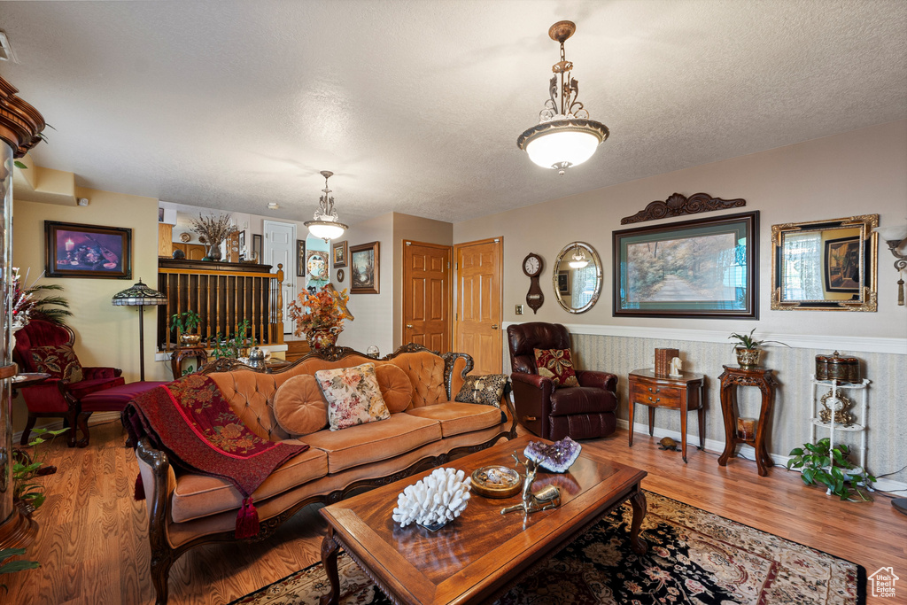 Living room featuring wood finished floors and a textured ceiling