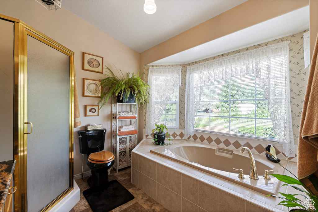 Full bathroom with a bath, a stall shower, and toilet
