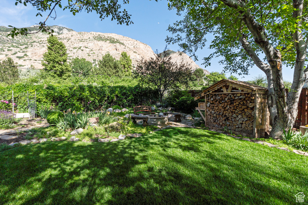View of yard with a mountain view and an outdoor fire pit