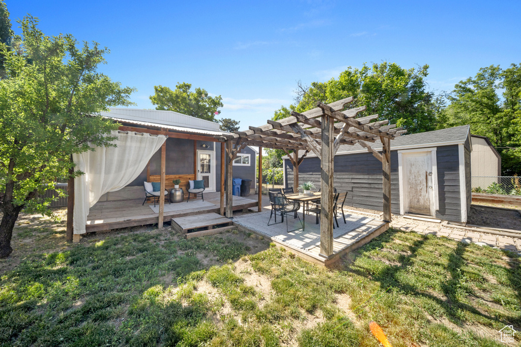 View of yard with a deck and a pergola