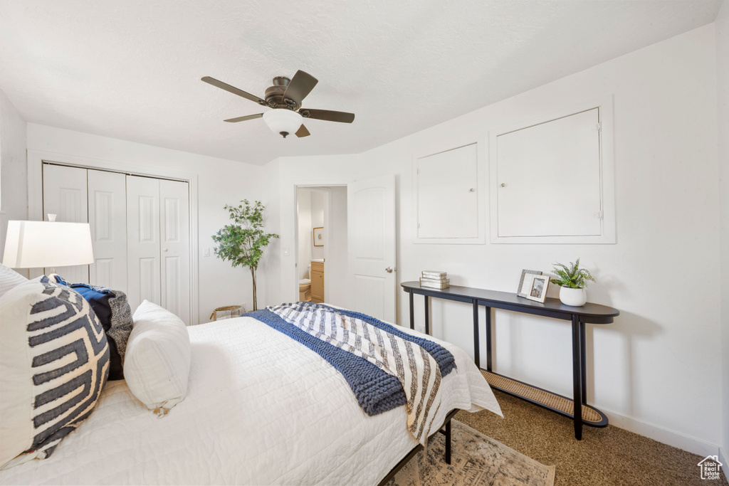 Carpeted bedroom featuring a closet, baseboards, and ceiling fan