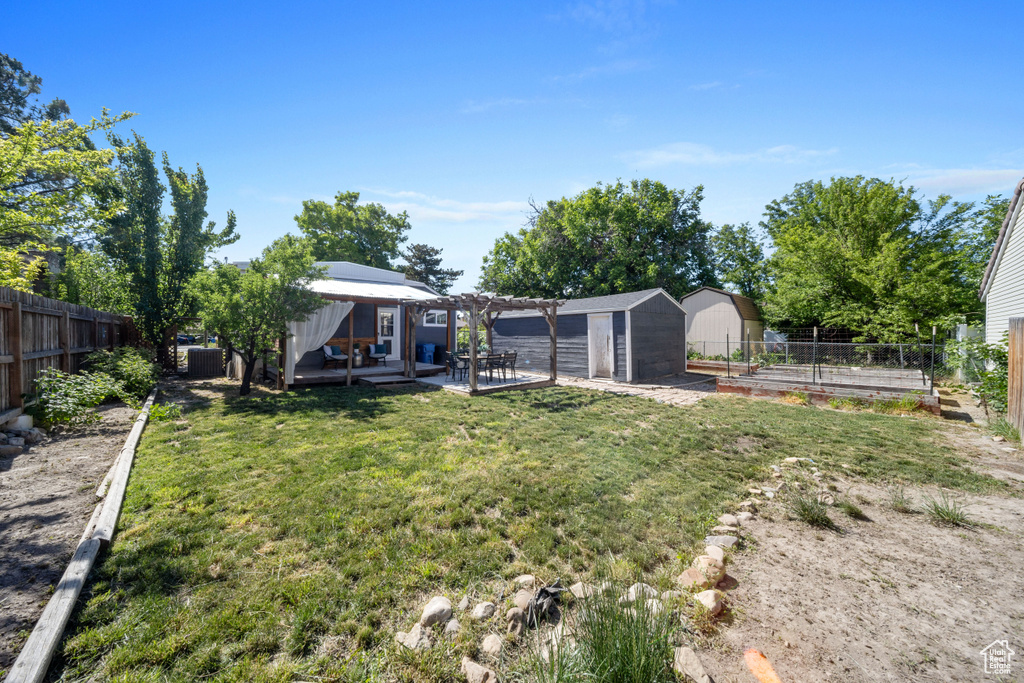 View of yard with a pergola and a patio