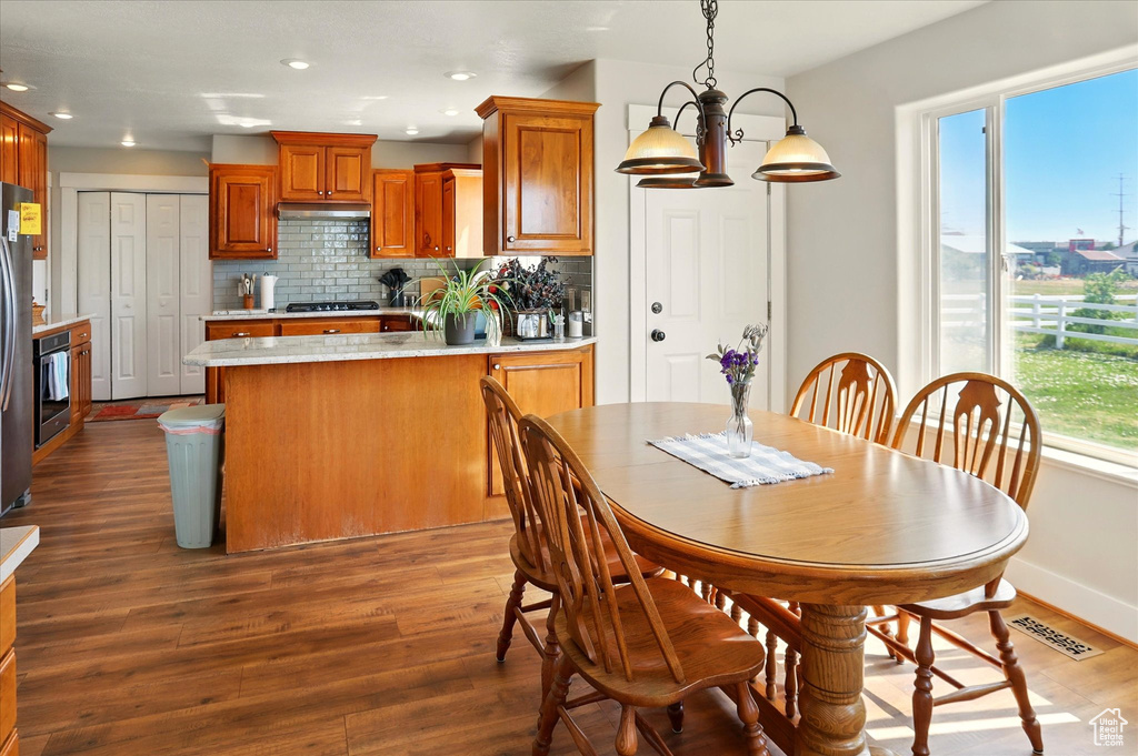 Dining space featuring dark wood-style flooring, recessed lighting, and baseboards