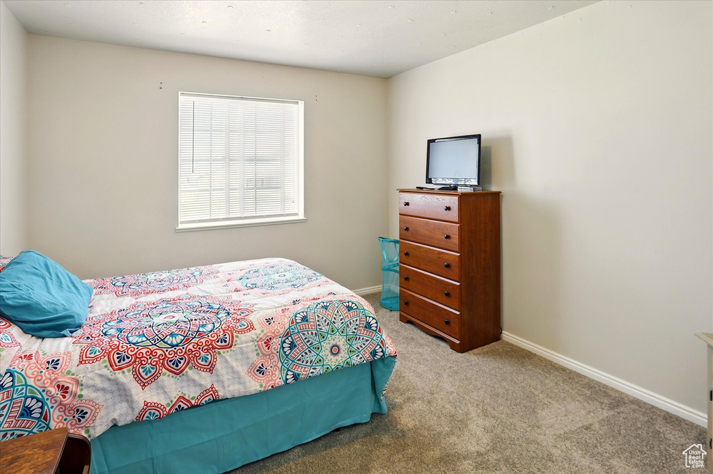 Bedroom featuring carpet flooring and baseboards