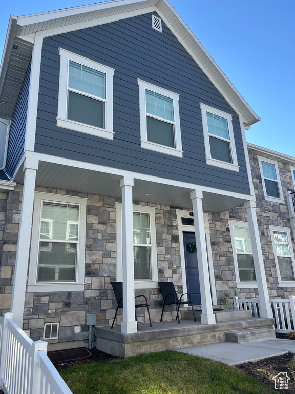 Multi unit property featuring covered porch and stone siding