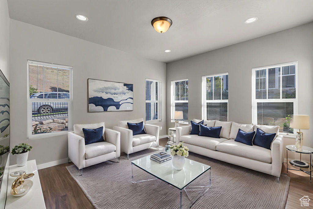 Living area with wood finished floors, baseboards, and recessed lighting