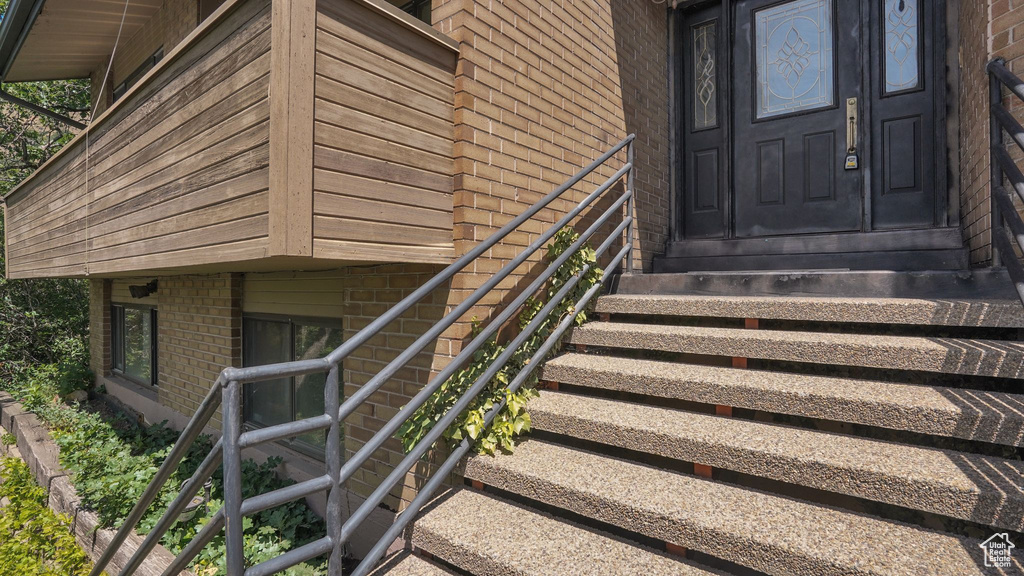 View of exterior entry featuring brick siding