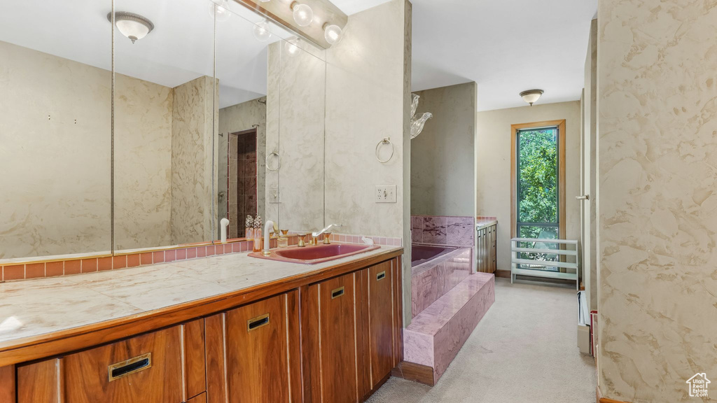 Bathroom with a bath and vanity