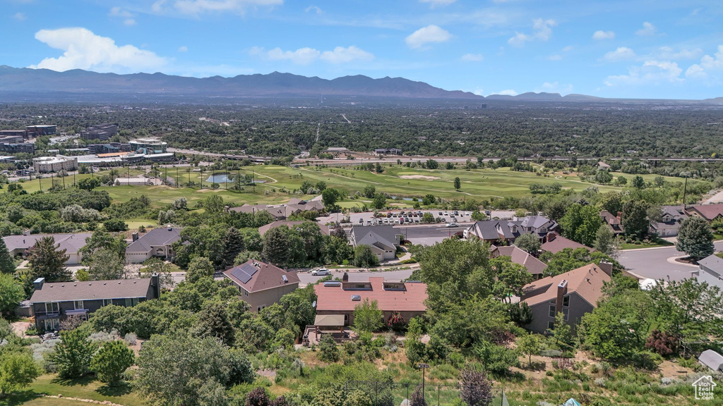 Aerial view of a mountainous background and a local golf course
