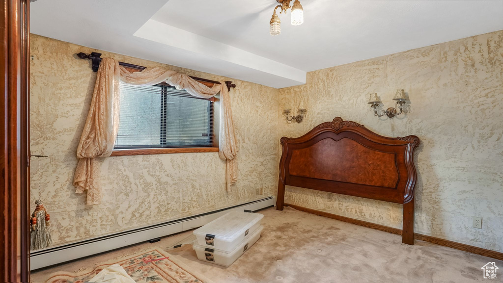 Bedroom featuring baseboard heating, light colored carpet, and baseboards