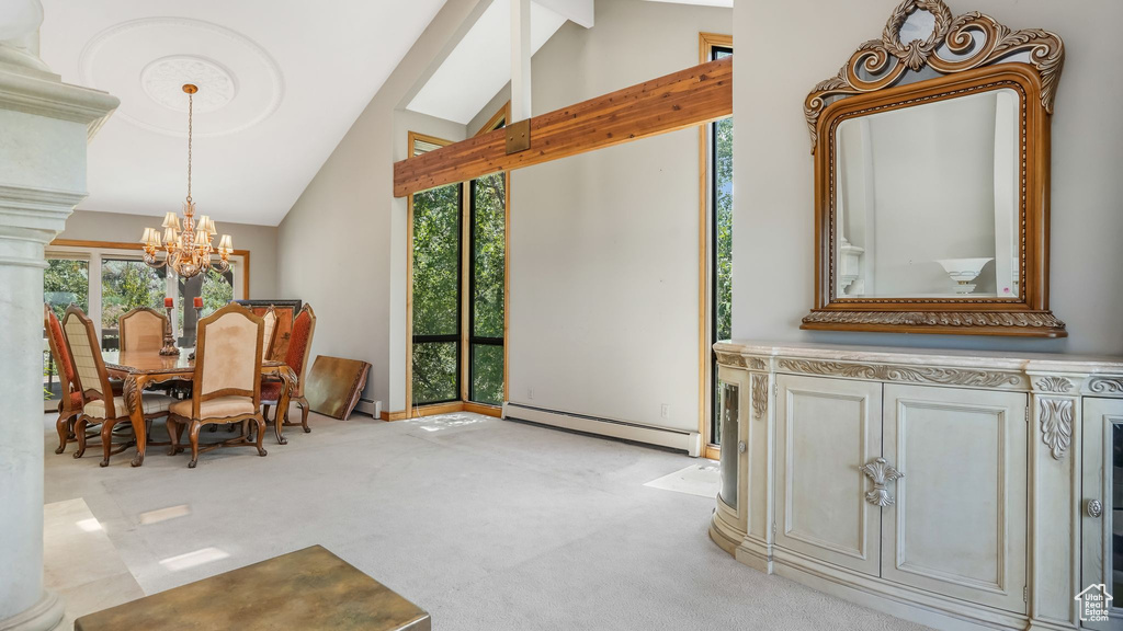 Carpeted dining space featuring a baseboard radiator, lofted ceiling, and a chandelier