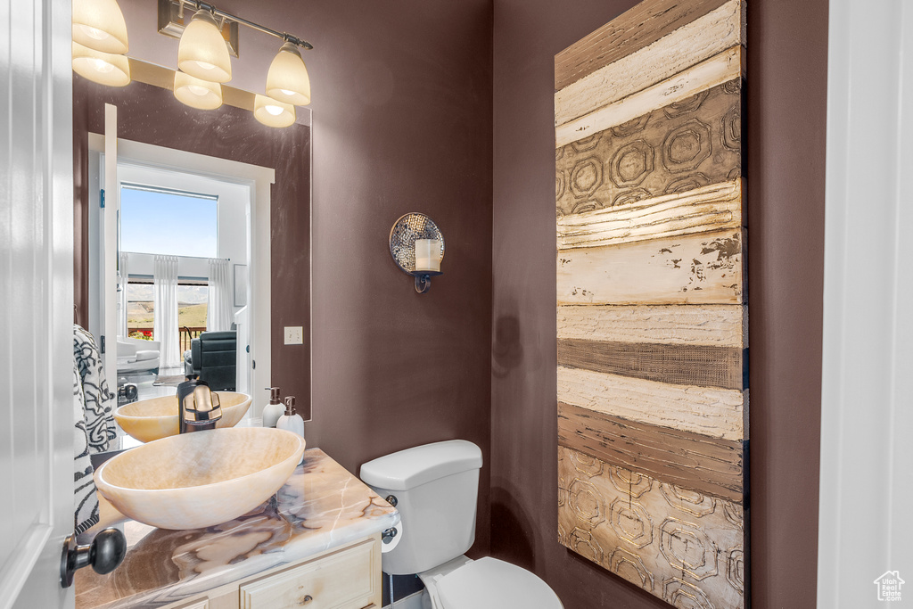 Half bathroom with vanity and toilet