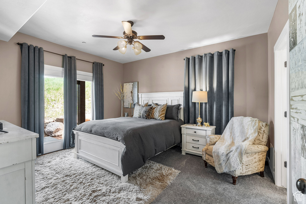 Carpeted bedroom featuring ceiling fan