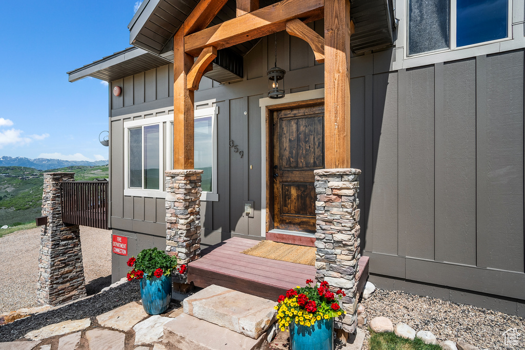 Property entrance with board and batten siding and a mountain view