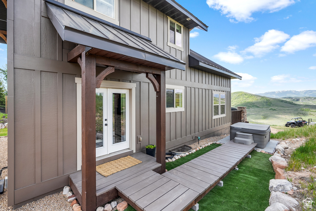 Wooden deck featuring french doors and a mountain view
