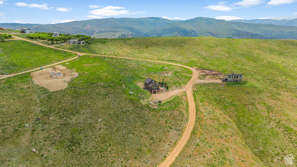 Aerial view of property and surrounding area with a mountainous background and rural landscape