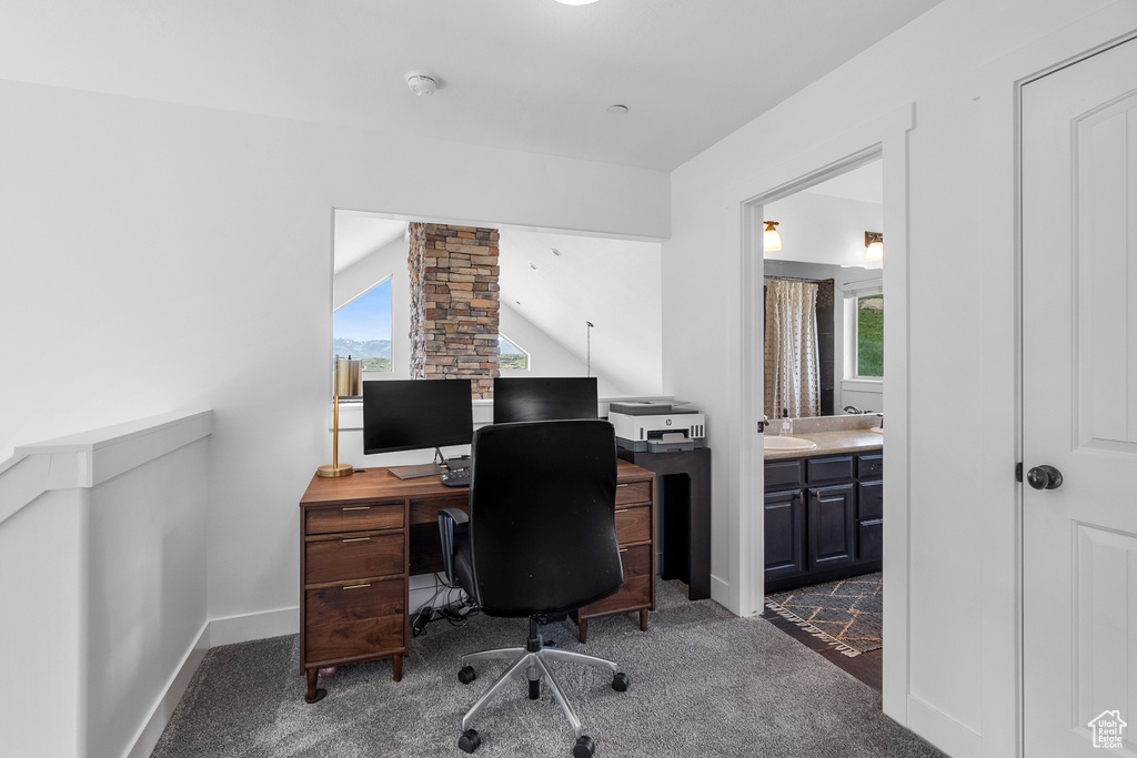 Office space featuring healthy amount of natural light, carpet floors, baseboards, and a sink