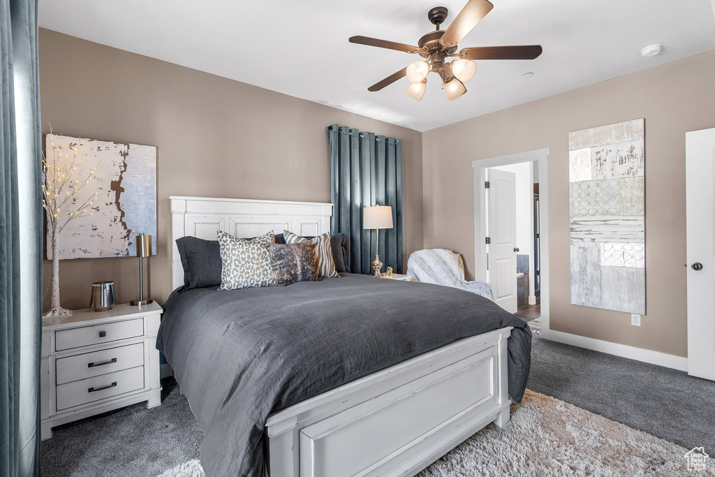 Bedroom with light carpet, baseboards, and a ceiling fan