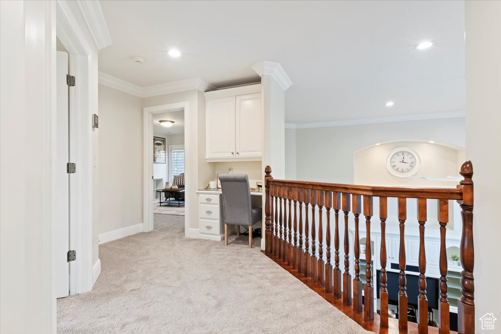 Hallway with light carpet, crown molding, baseboards, an upstairs landing, and recessed lighting