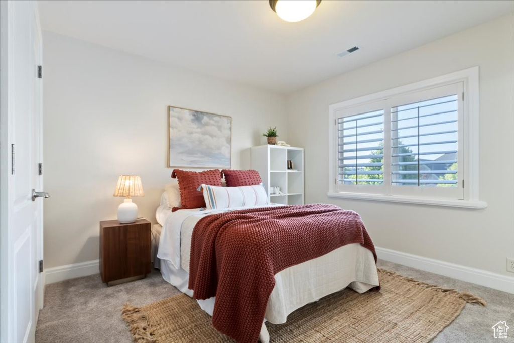 Carpeted bedroom featuring baseboards