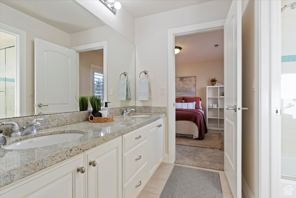 Bathroom with double vanity, ensuite bath, and tile patterned floors