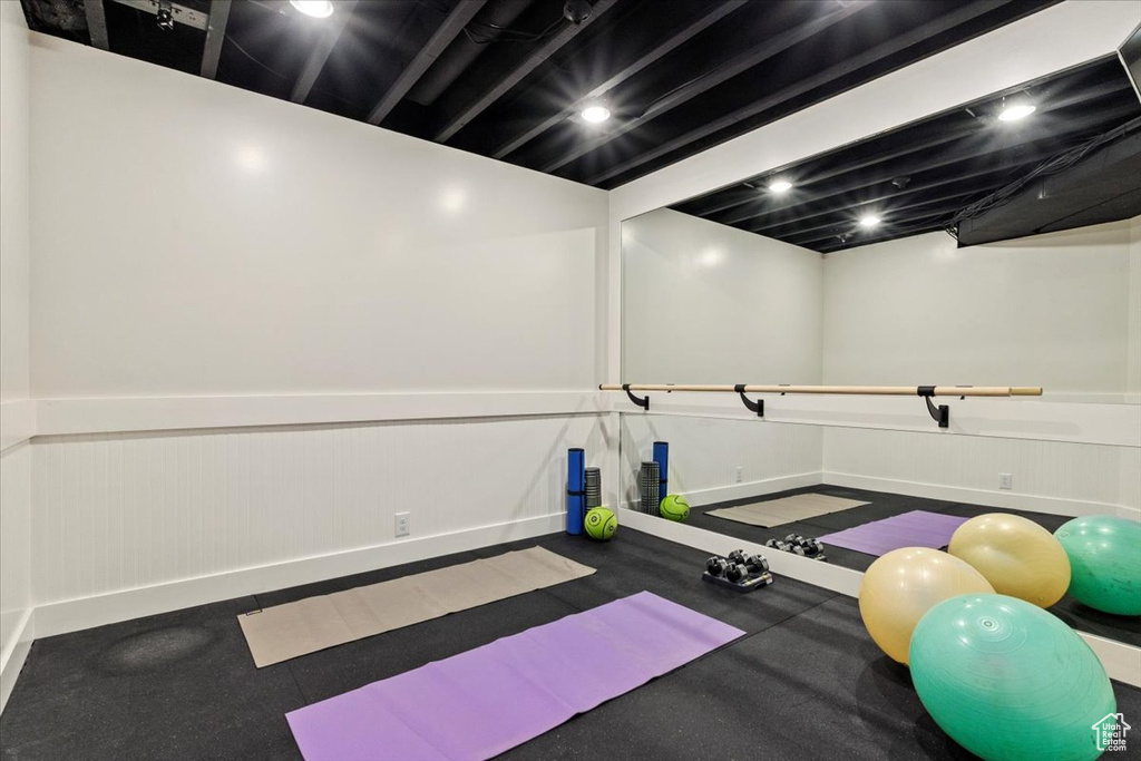 Workout area with a wainscoted wall