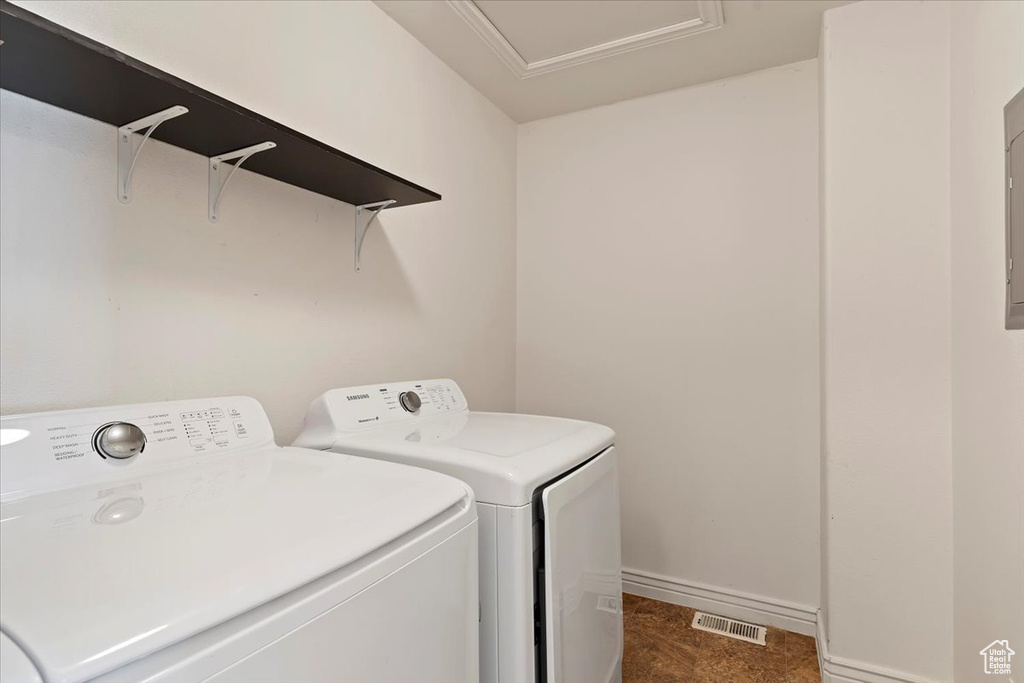 Laundry area featuring washing machine and clothes dryer and baseboards
