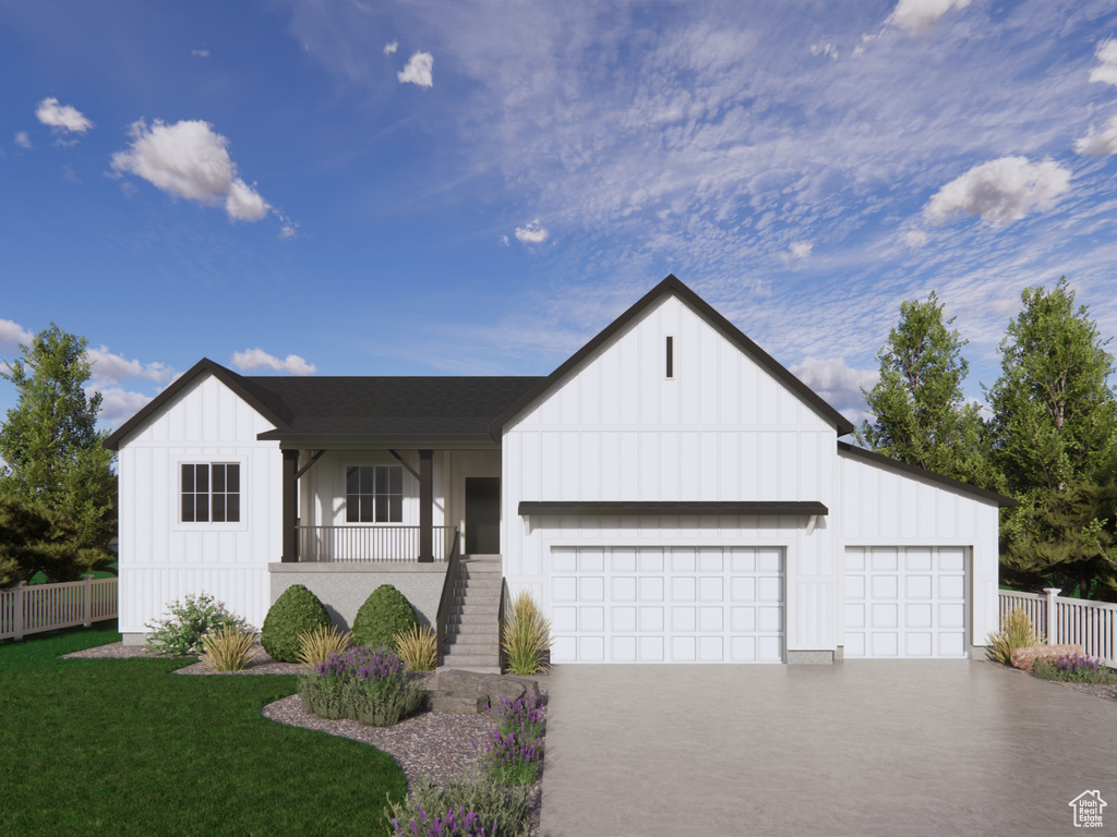Modern inspired farmhouse featuring board and batten siding, driveway, and a garage